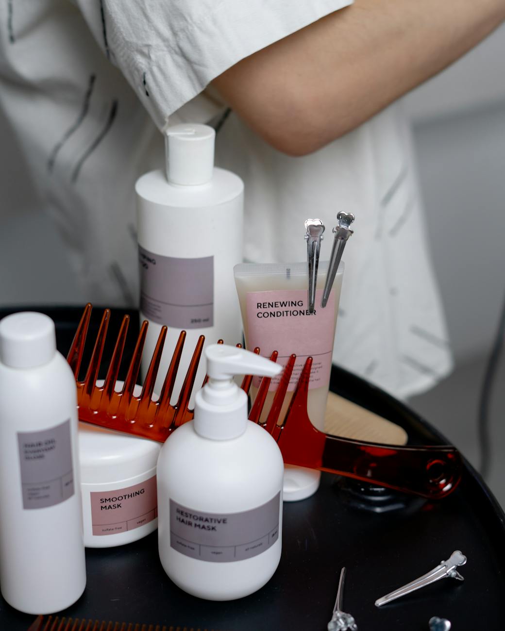 A collection of haircare products including shampoos, conditioners, and combs neatly arranged on a table.